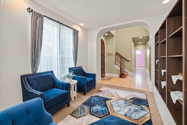 12696 NW Alsace Ln, Portland, OR 97229 - living area with arched walkways, plenty of natural light, stairs, recessed lighting, and tile patterned flooring