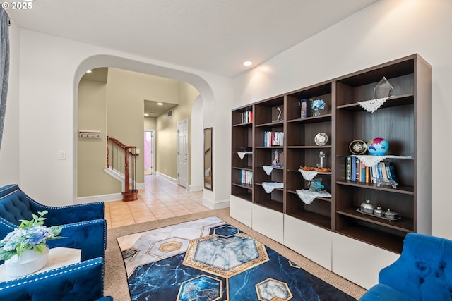 12696 NW Alsace Ln, Portland, OR 97229 - living area featuring arched walkways, tile patterned floors, stairway, recessed lighting, and baseboards