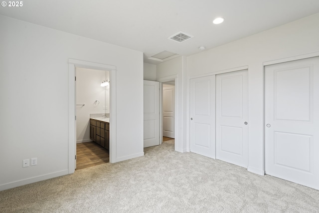 469 N 35th, Springfield, OR 97478 - unfurnished bedroom featuring light carpet, baseboards, connected bathroom, recessed lighting, and multiple closets