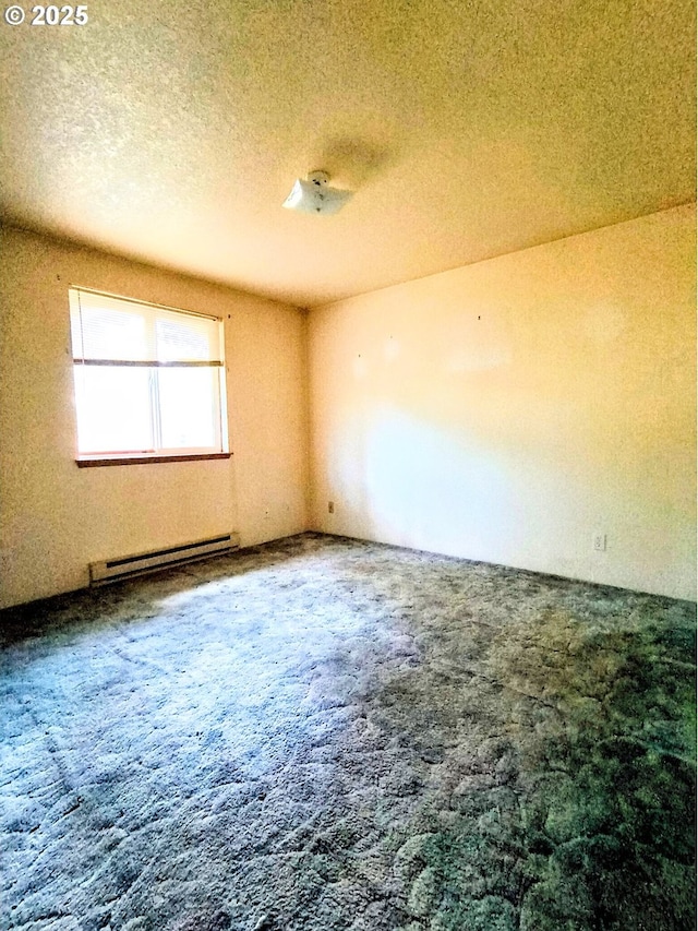 444 Char St, Roseburg, OR 97471 - unfurnished room featuring a baseboard heating unit, carpet, and a textured ceiling