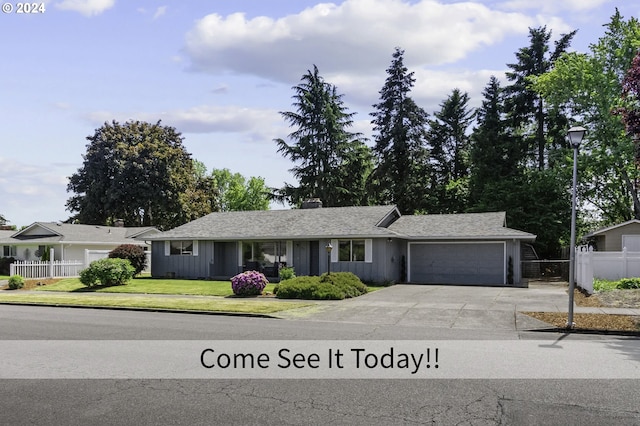 5323 Verda Ln, Keizer, OR 97303 - single story home featuring an attached garage, driveway, a chimney, and board and batten siding
