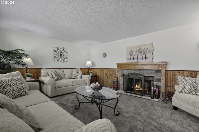 5323 Verda Ln, Keizer, OR 97303 - living room featuring carpet flooring, wooden walls, a wainscoted wall, a fireplace, and a textured ceiling