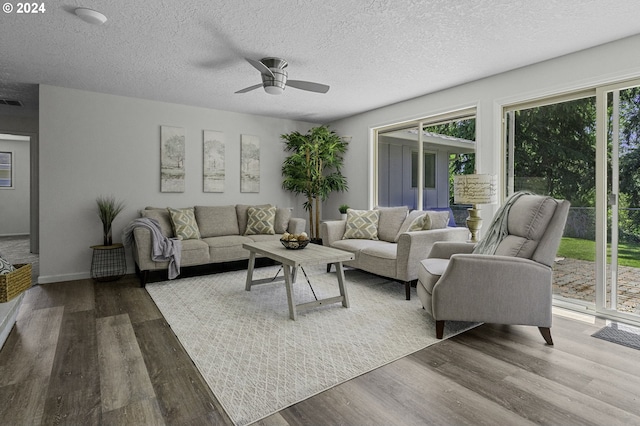 5323 Verda Ln, Keizer, OR 97303 - living room with a ceiling fan, wood finished floors, a textured ceiling, and baseboards