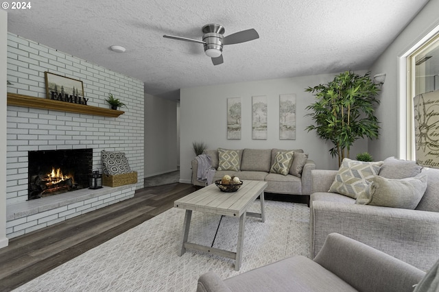 5323 Verda Ln, Keizer, OR 97303 - living area with ceiling fan, wood finished floors, a textured ceiling, a fireplace, and baseboards