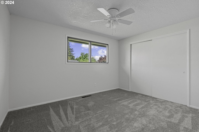 5323 Verda Ln, Keizer, OR 97303 - unfurnished bedroom with carpet flooring, a closet, a textured ceiling, baseboards, and a ceiling fan