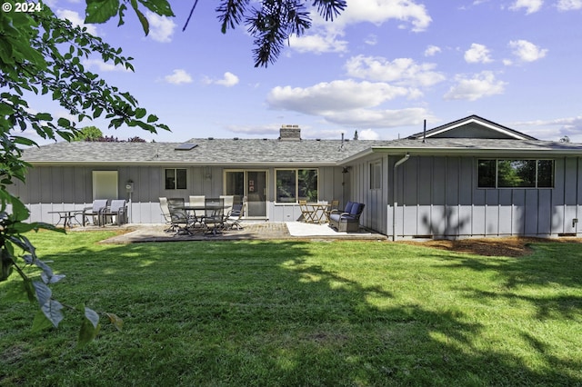 5323 Verda Ln, Keizer, OR 97303 - rear view of property with board and batten siding, a chimney, a patio, a lawn, and roof with shingles