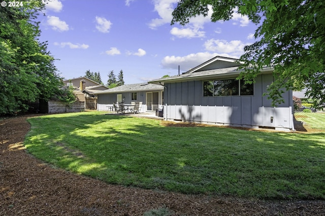 5323 Verda Ln, Keizer, OR 97303 - rear view of house with board and batten siding, a patio area, and a lawn