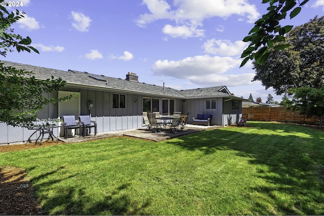 5323 Verda Ln, Keizer, OR 97303 - back of house featuring board and batten siding, a chimney, a patio area, and a shingled roof