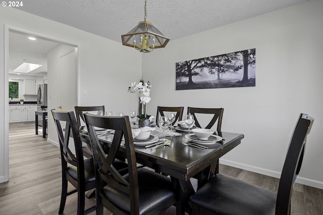 5323 Verda Ln, Keizer, OR 97303 - dining area with a chandelier, light wood-style floors, baseboards, recessed lighting, and a textured ceiling