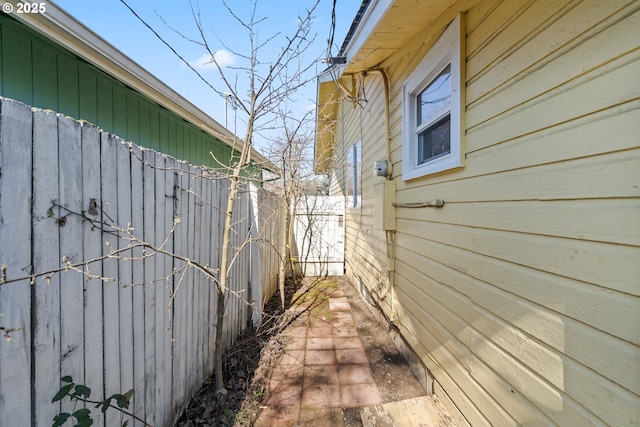 view of side of home featuring fence