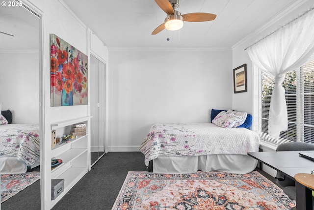 carpeted bedroom with ceiling fan, ornamental molding, and baseboards