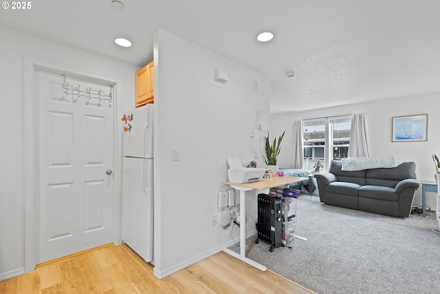 living room featuring light wood-style flooring, baseboards, and recessed lighting