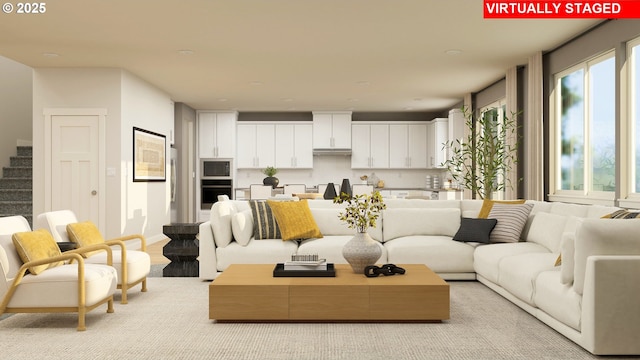 living area featuring stairs and baseboards