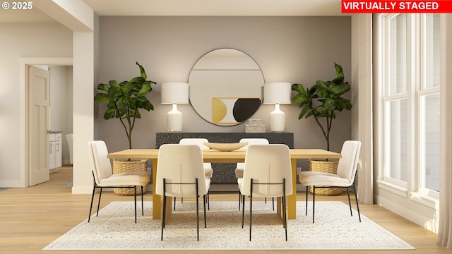 dining area featuring wood finished floors and baseboards