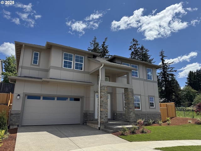 13998 SW 165th Ave, Tigard, OR 97223 - view of front facade with stone siding, driveway, an attached garage, and fence