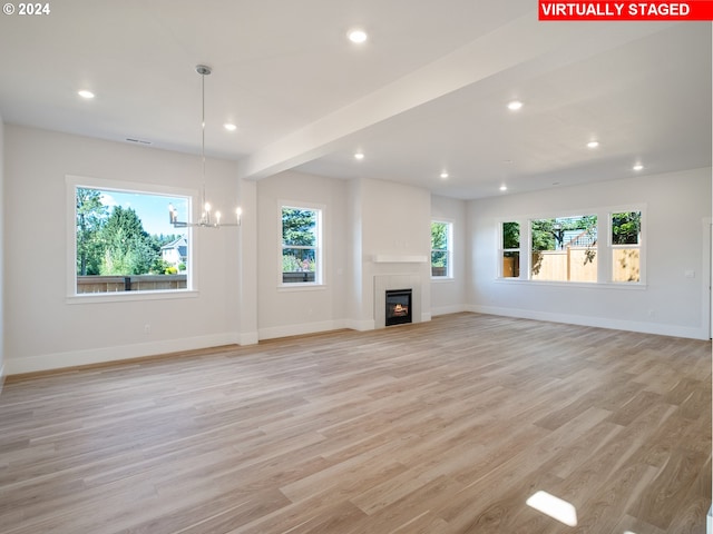 13998 SW 165th Ave, Tigard, OR 97223 - unfurnished living room with recessed lighting, light wood-style flooring, a chandelier, and a fireplace