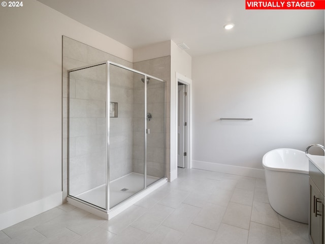 13998 SW 165th Ave, Tigard, OR 97223 - bathroom with a stall shower, baseboards, tile patterned flooring, a soaking tub, and recessed lighting