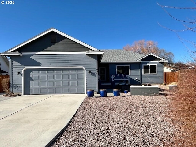 single story home featuring an attached garage, concrete driveway, and fence