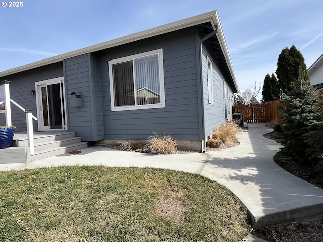 view of front of house with a front yard and fence