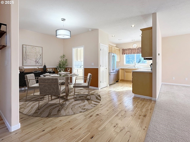 dining space with recessed lighting, baseboards, and light wood-style flooring