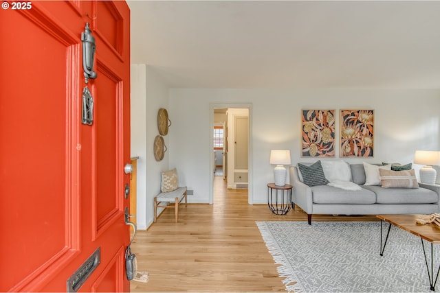 living room featuring light wood-style flooring and baseboards