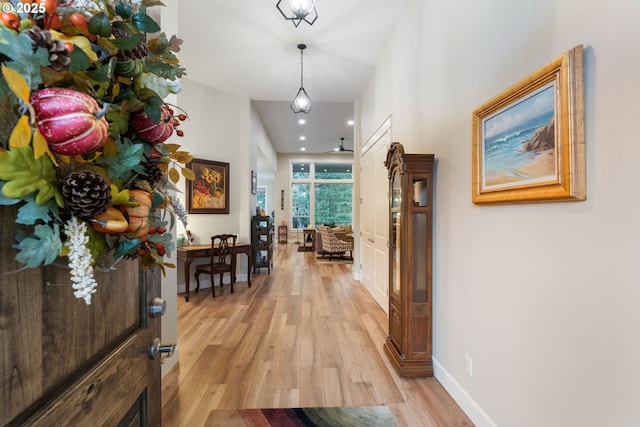 corridor with light hardwood / wood-style floors