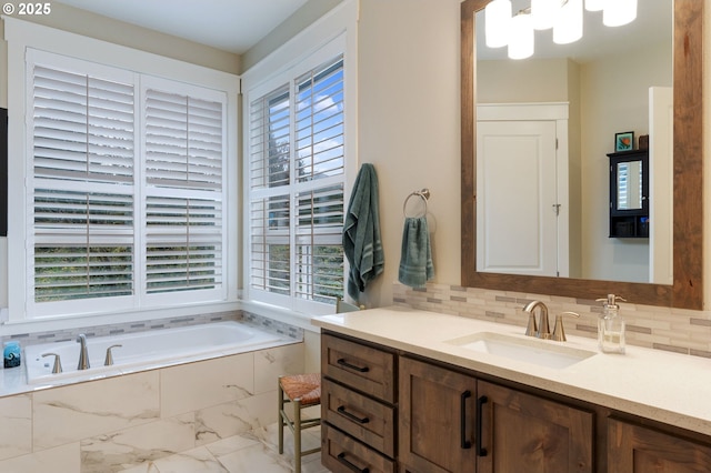 bathroom featuring plenty of natural light, tiled bath, and decorative backsplash