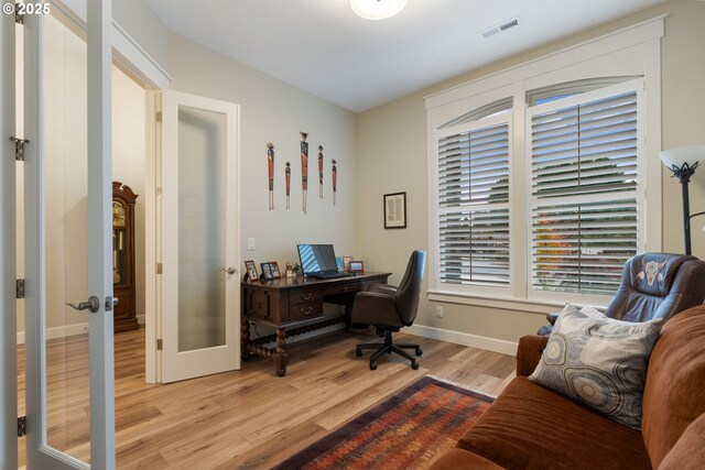 office with light hardwood / wood-style flooring