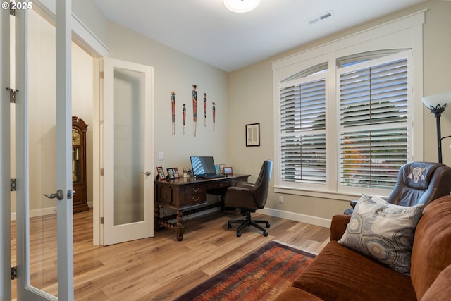 office space featuring french doors and light wood-type flooring