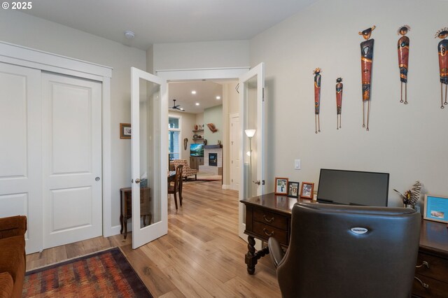 home office featuring light wood-type flooring and french doors