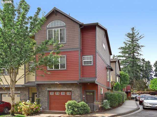 view of front facade featuring an attached garage and stone siding