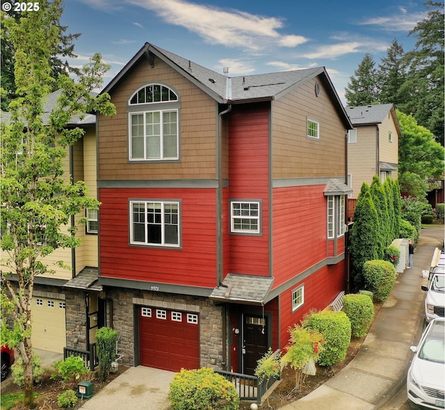 9575 SW Tephra Ter, Beaverton, OR 97007 - view of front of house featuring an attached garage, stone siding, and concrete driveway
