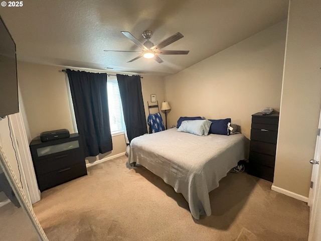 bedroom featuring light carpet, baseboards, and a ceiling fan