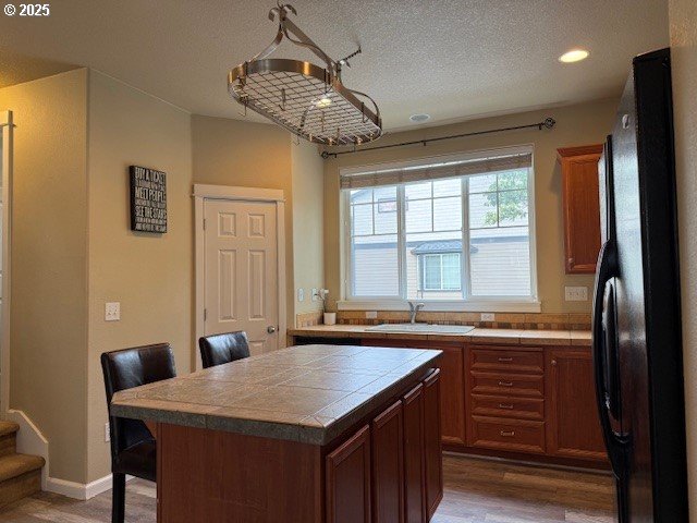 9575 SW Tephra Ter, Beaverton, OR 97007 - office space featuring a sink, light wood-type flooring, recessed lighting, and a textured ceiling