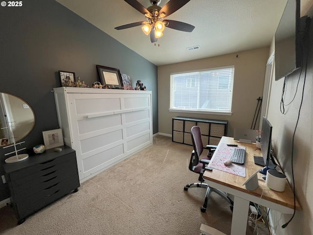 office space featuring carpet floors, lofted ceiling, ceiling fan, and baseboards