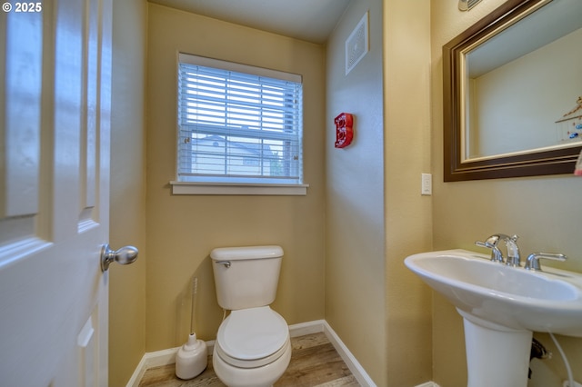 9575 SW Tephra Ter, Beaverton, OR 97007 - half bathroom with toilet, baseboards, and wood finished floors