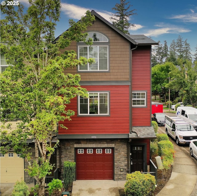 9575 SW Tephra Ter, Beaverton, OR 97007 - view of front of home with stone siding and an attached garage