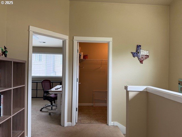 9575 SW Tephra Ter, Beaverton, OR 97007 - hall with carpet floors, an office area, and baseboards