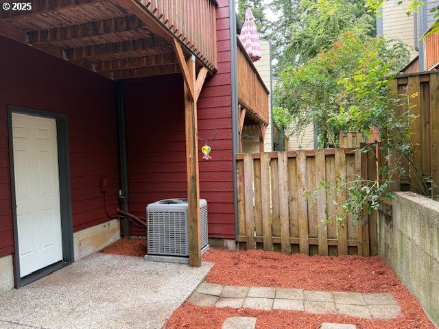 view of patio with fence and central air condition unit
