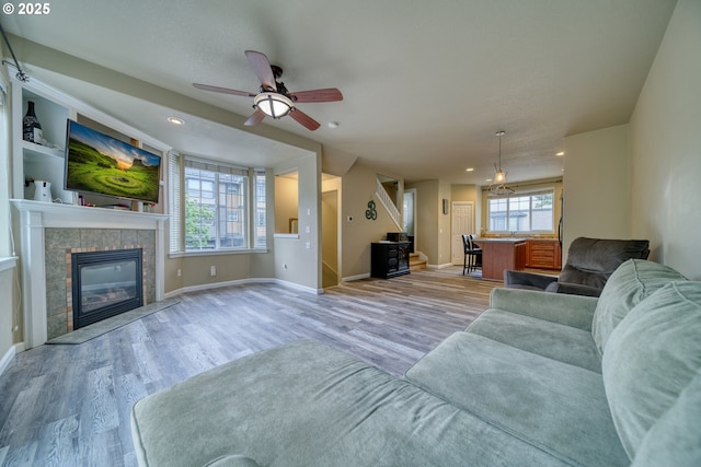 9575 SW Tephra Ter, Beaverton, OR 97007 - living area featuring wood finished floors, ceiling fan, baseboards, recessed lighting, and a tile fireplace