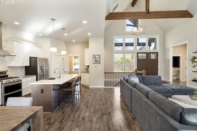 21420 NE Red Hills Ln, Dundee, OR 97115 - kitchen featuring stainless steel appliances, high vaulted ceiling, wall chimney range hood, open floor plan, and a breakfast bar area