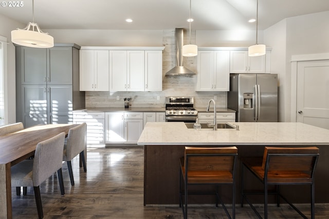 21420 NE Red Hills Ln, Dundee, OR 97115 - kitchen featuring appliances with stainless steel finishes, wall chimney exhaust hood, backsplash, light stone countertops, and pendant lighting