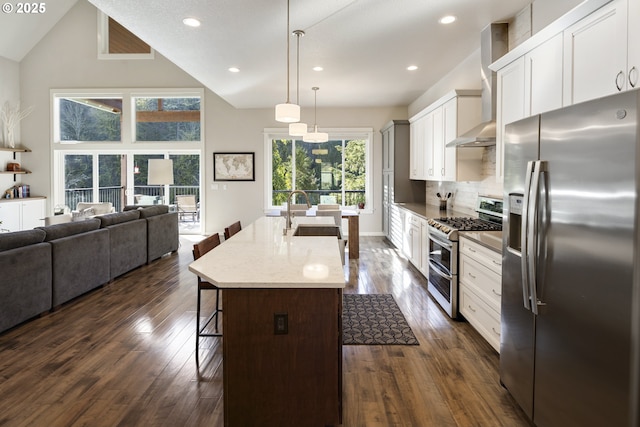 21420 NE Red Hills Ln, Dundee, OR 97115 - kitchen with stainless steel appliances, wall chimney exhaust hood, a breakfast bar, dark wood-type flooring, and an island with sink