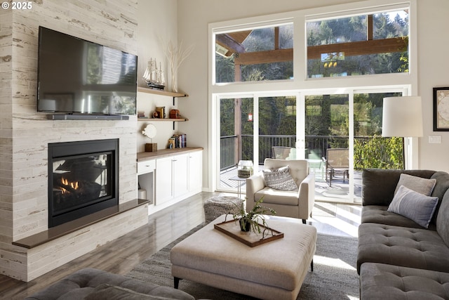 21420 NE Red Hills Ln, Dundee, OR 97115 - living area featuring wood finished floors, a stone fireplace, and a towering ceiling