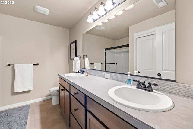 full bathroom featuring baseboards, visible vents, a sink, and a stall shower