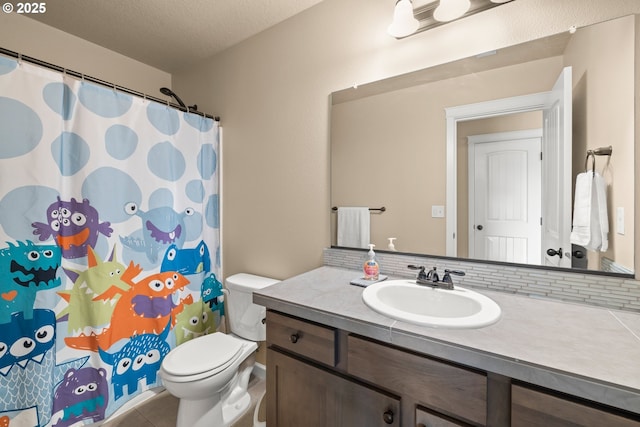 bathroom featuring tile patterned floors, vanity, curtained shower, and toilet