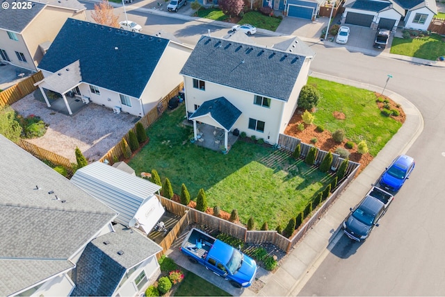 birds eye view of property with a residential view