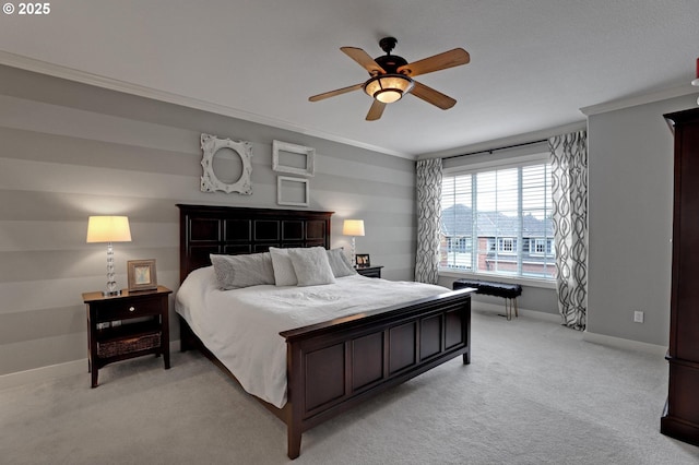 bedroom featuring light carpet, baseboards, ornamental molding, and ceiling fan