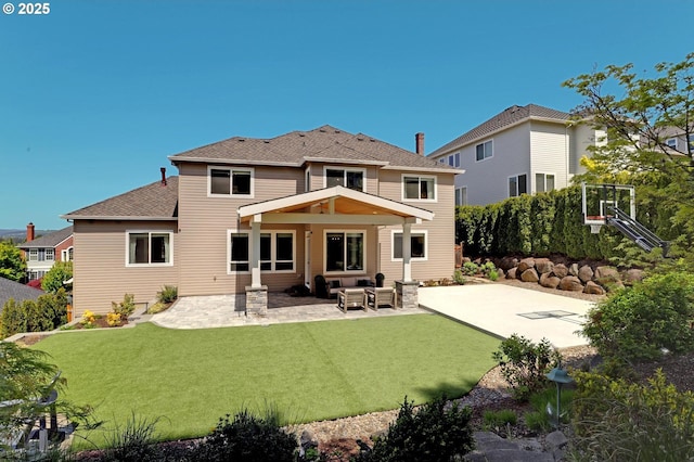 rear view of house featuring roof with shingles, a patio, and an outdoor living space