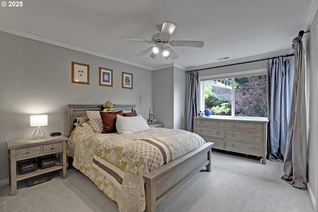 bedroom featuring light colored carpet, ornamental molding, and a ceiling fan